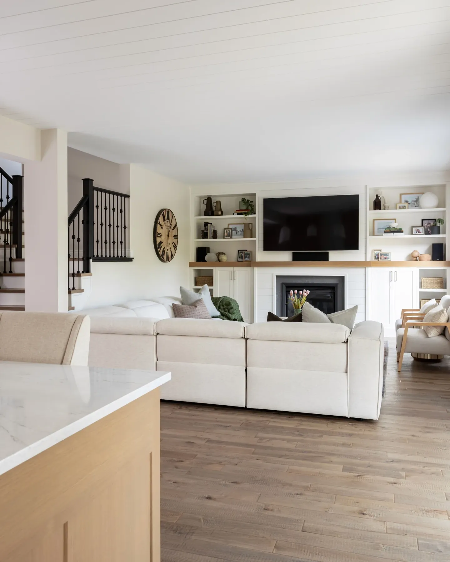 Family room with fireplace built-ins and an open staircase