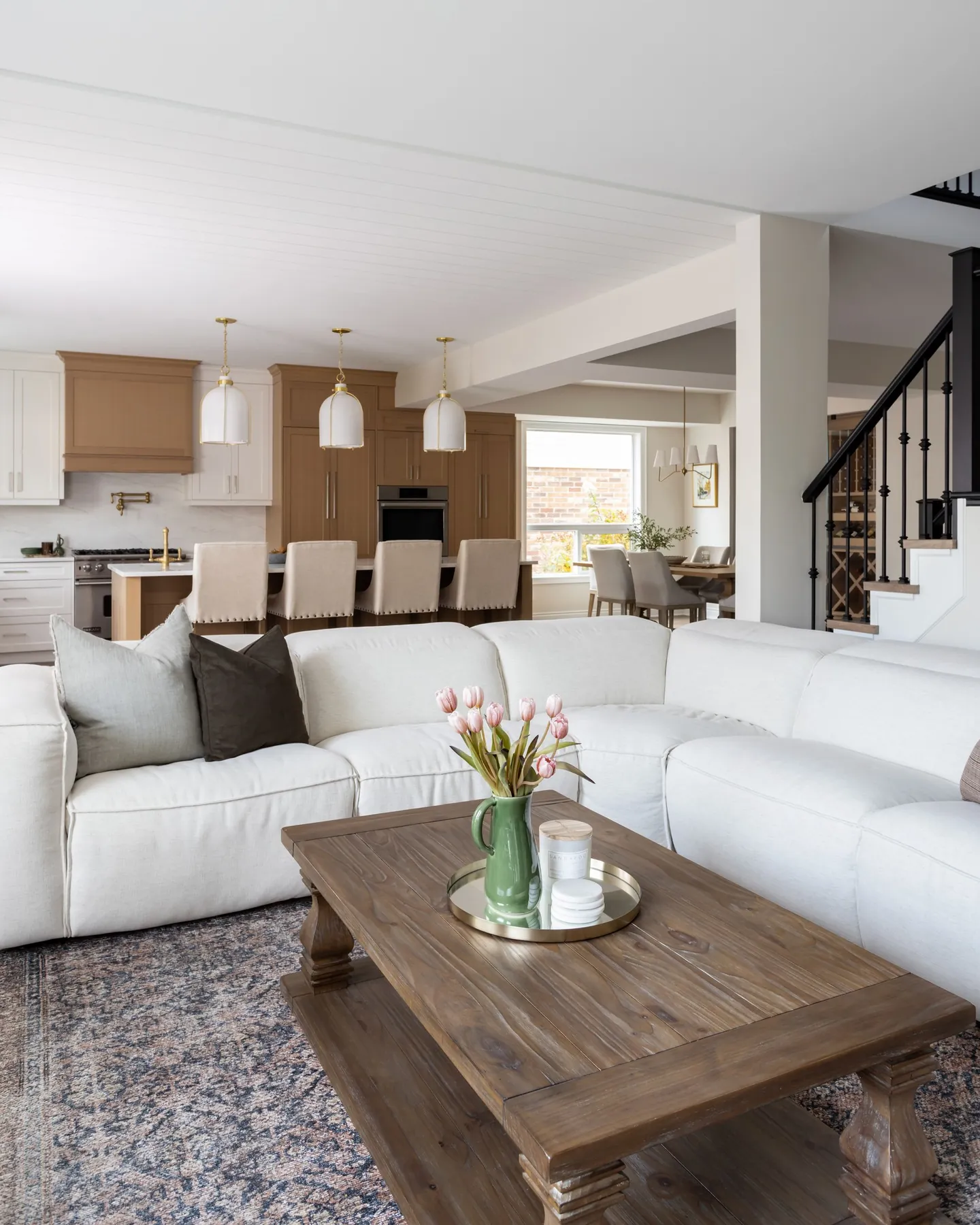 Open-plan living room looking through to a renovated kitchen